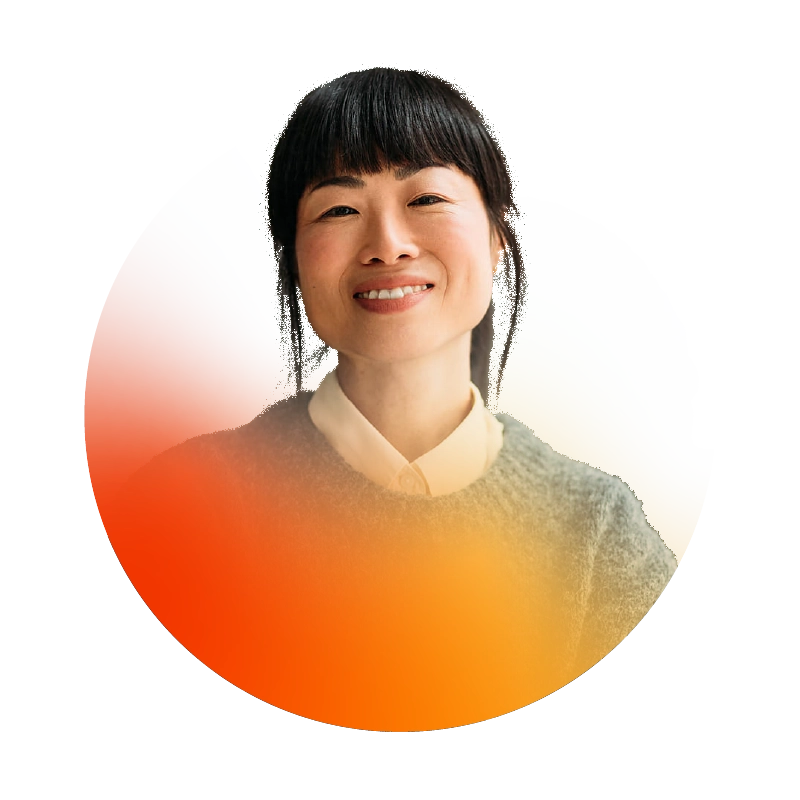 business man sitting at a table wearing red glasses